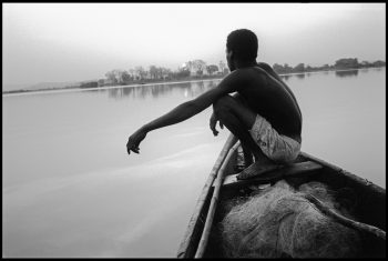 MALI. Bamako. At sunrise, a fisherman in his boat on the river Niger. 1994.